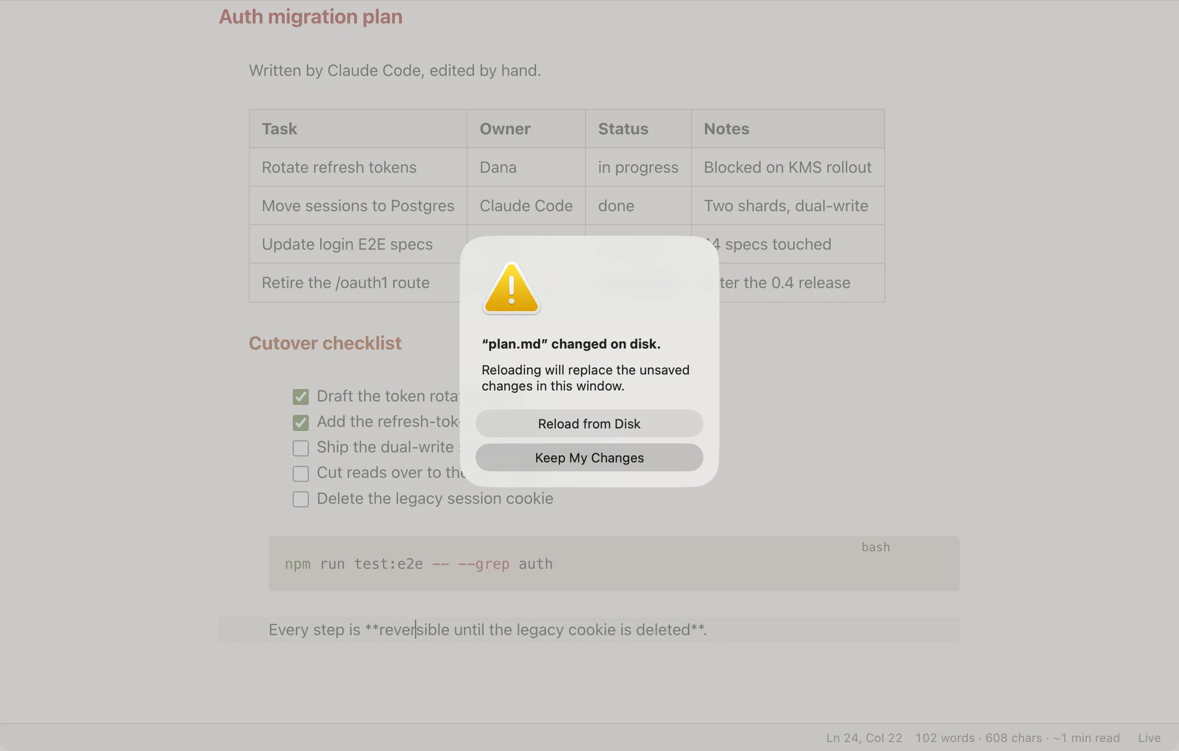 A native sheet over the plan reading: plan.md changed on disk. Reloading will replace the unsaved changes in this window. Two buttons: Reload from Disk and Keep My Changes.